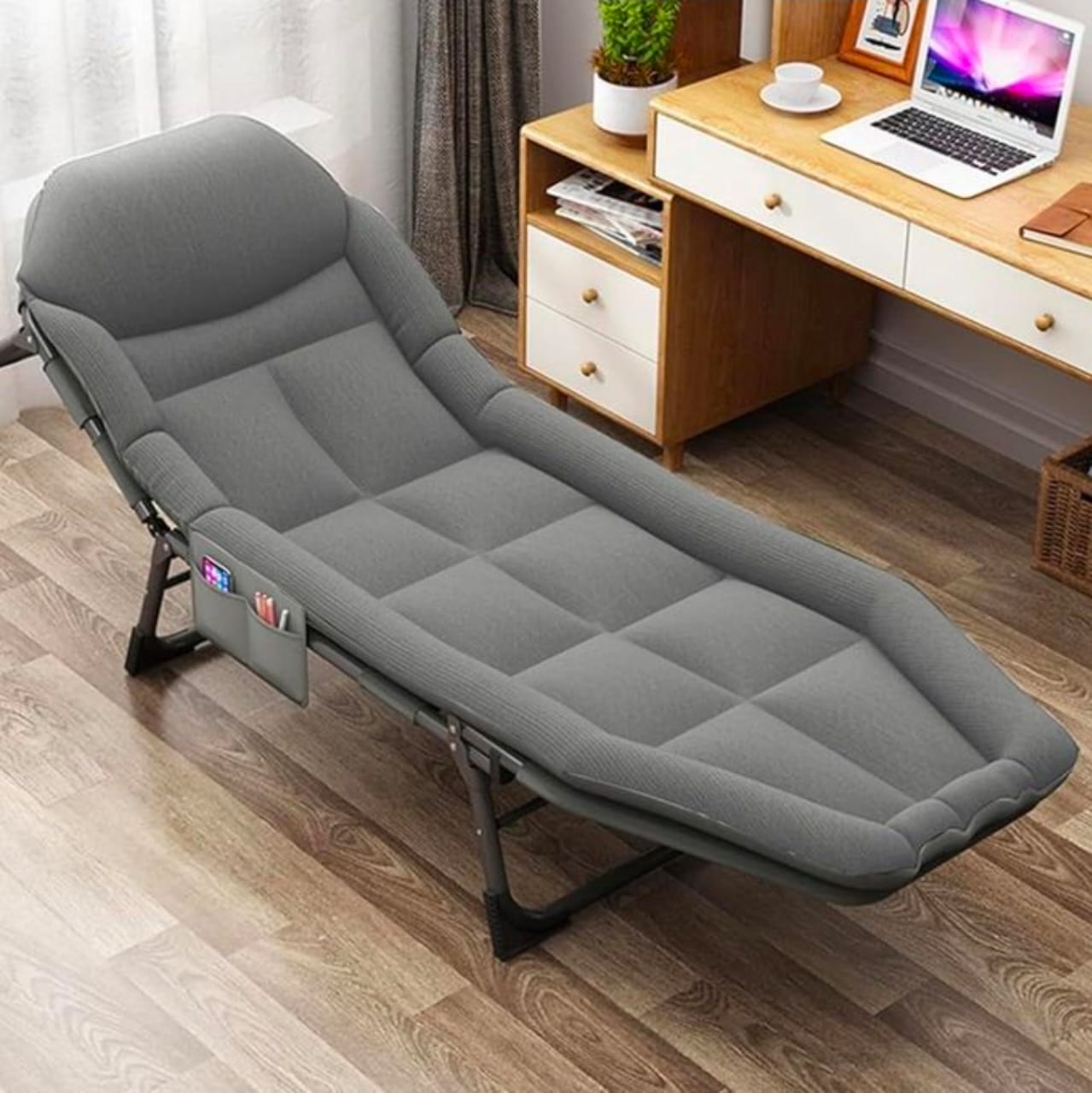 versatile, foldable grey camping bed that features a multi-position backrest and a side storage pocket for convenience.